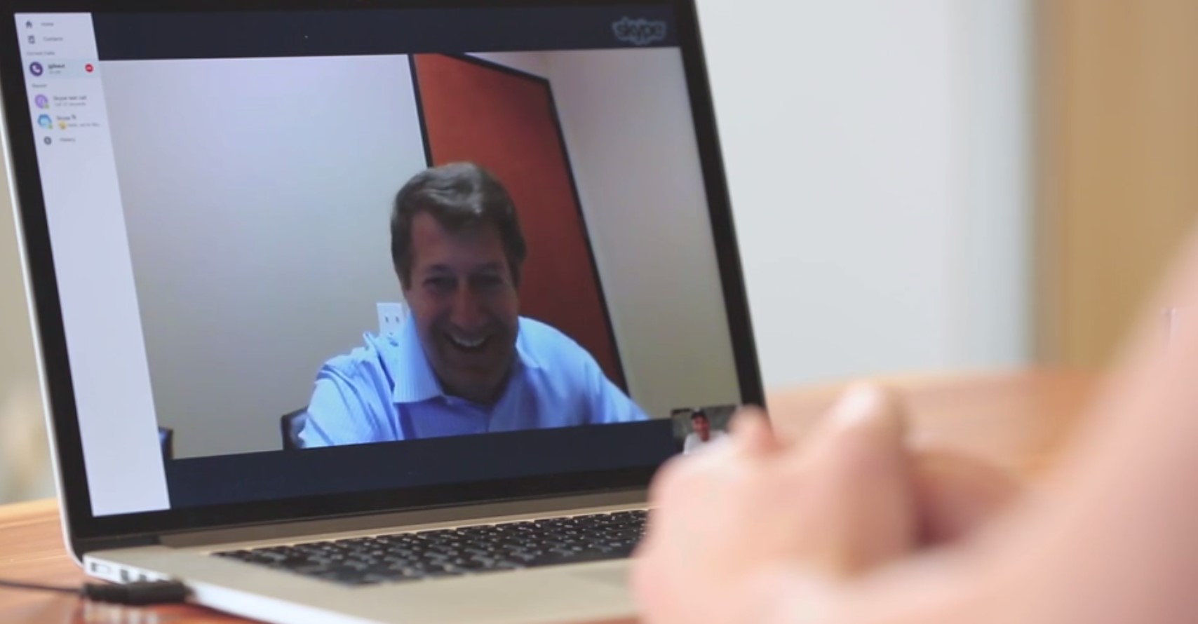 Branch Manager Dan Peterson reacts in surprise when ambushed via Skype by CEO Casey Crawford.