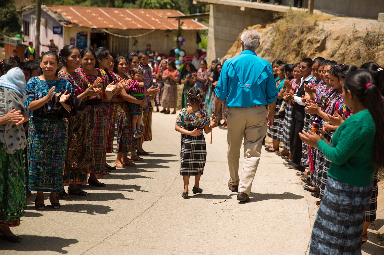 Movement co-founder Toby Harris walks with a little girl in Guatemala. 